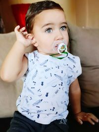 Portrait of cute boy sitting at home