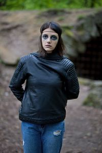 Portrait of young woman standing outdoors