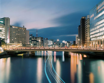 Reflection of illuminated city in water at night