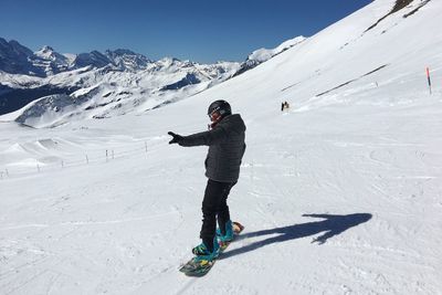 Full length of person skiing on snowcapped mountain