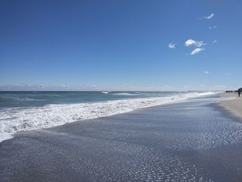 Scenic view of beach against clear blue sky