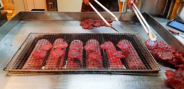 High angle view of meat on barbecue grill