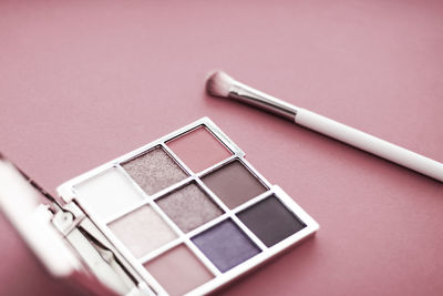 Close-up of beauty products against pink background