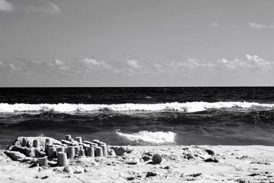 Scenic view of beach against sky on sunny day