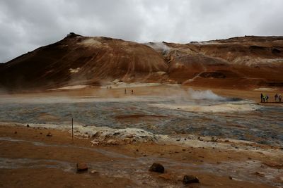 View of desert against cloudy sky