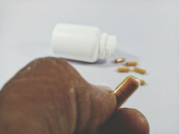 Close-up of hand holding cigarette