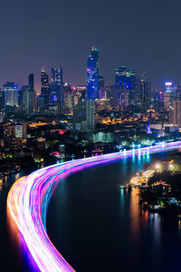 Illuminated buildings against sky at night