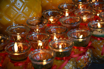 High angle view of burning tea lights