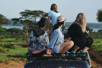 Women looking away while sitting on land vehicle 