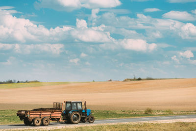 Tractor on field against sky