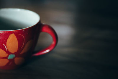 Close-up of red cup on table