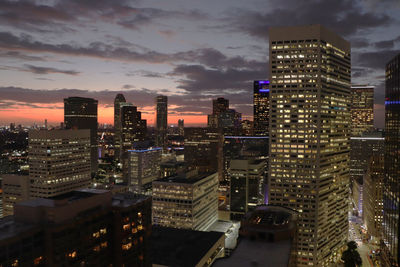 High angle view of illuminated buildings against sky at night