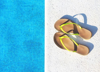 High angle view of shoes on swimming pool