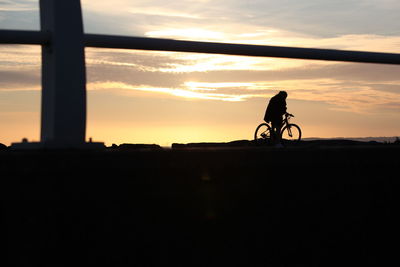 Silhouetted cyclist.