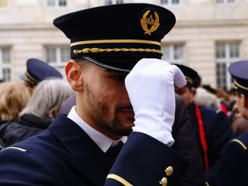 Close-up of sailor in military uniform standing on street