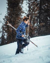 Man skiing on field during winter