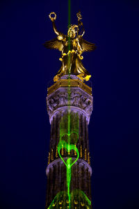 Low angle view of statue of liberty against sky at night