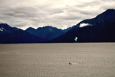 Scenic view of sea and mountains against sky