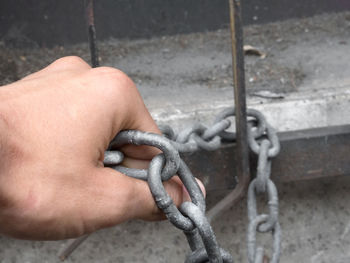 Cropped hand holding chain