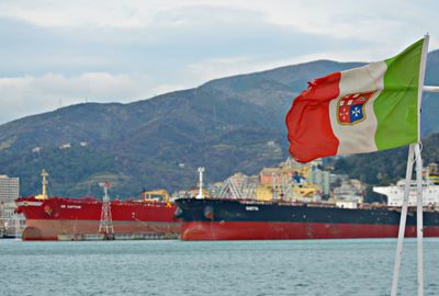 Scenic view of flag by mountain against sky