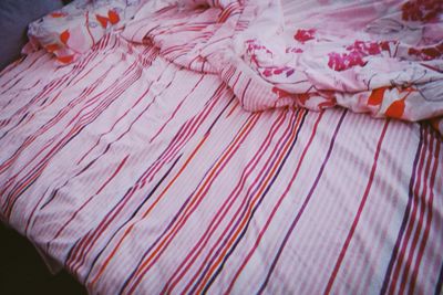 High angle view of pink petals on bed