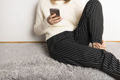 Midsection of woman using mobile phone