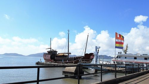 Ship moored in sea against sky