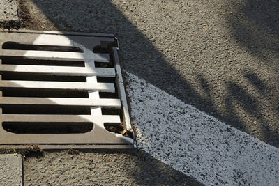 High angle view of metal grate on street