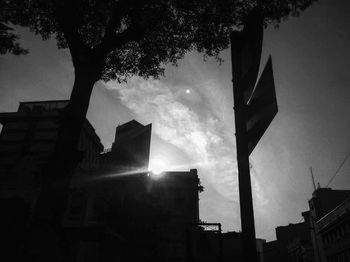 Low angle view of silhouette buildings against sky