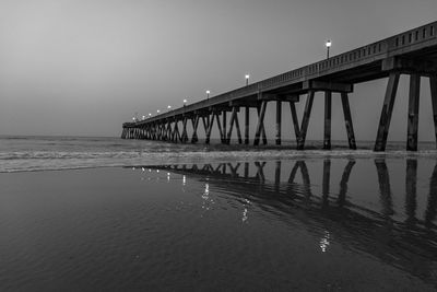 Pier over sea against clear sky