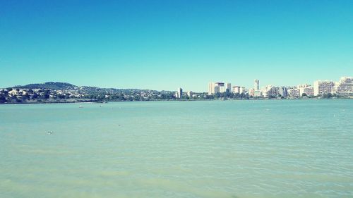 Scenic view of sea against clear blue sky