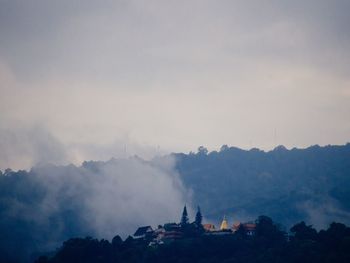 Temple by mountain against sky