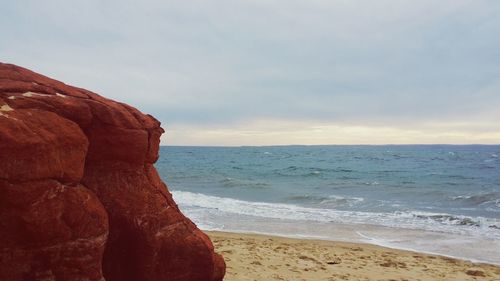 Scenic view of sea against cloudy sky