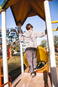 Portrait of boy in playground slide