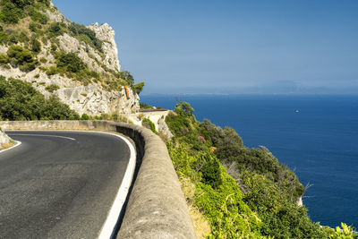 Road by sea against sky