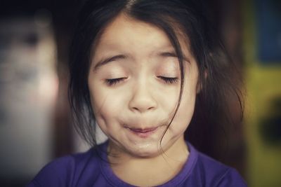 Close-up of cute girl with eyes closed