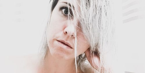 Close-up portrait of woman against white background