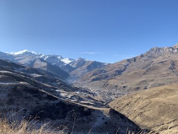 Scenic view of mountains against clear blue sky