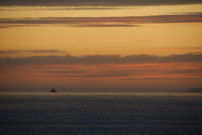 Scenic view of sea against orange sky