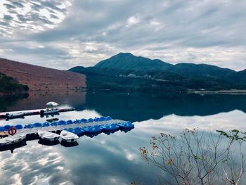 Scenic view of lake and mountains against sky