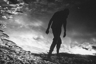 High angle view of man reflecting in puddle