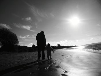 Men on beach against sky