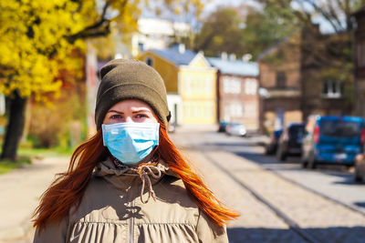 Portrait of woman standing on street in city