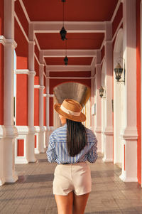 Rear view of woman standing by railing