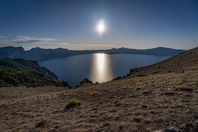 Scenic view of lake and mountains against sky