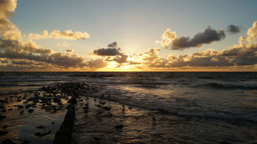 View of calm beach at sunset