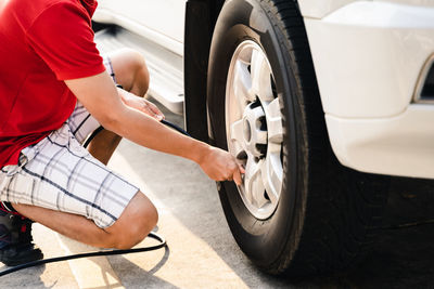 Low section of man holding car