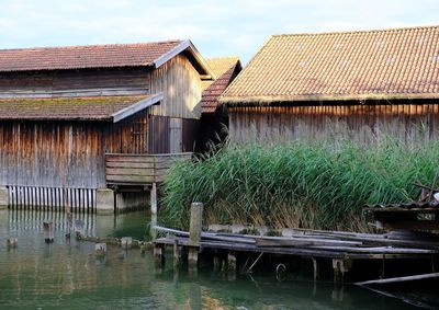 Built structure in lake against sky