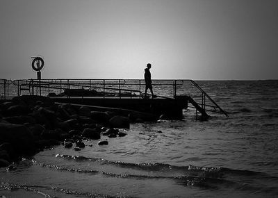 Pier on sea against clear sky