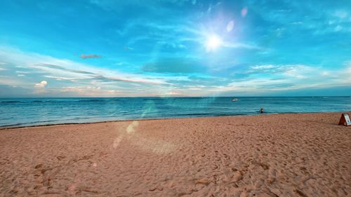 Scenic view of beach against blue sky